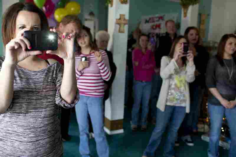 Lorrie Ward, left, joins the family and friends of Ernie Lopez as he enters the family home. Ward was the live-in nanny of Isis Vas, the baby girl who was at the center of Lopez's case. Ward has since become very close to the Lopez family and is a strong supporter of Ernie.