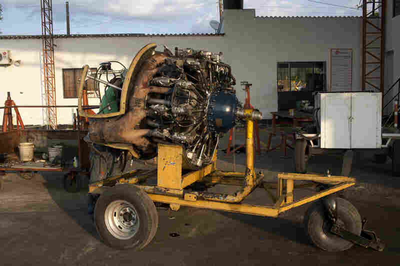 A mechanic works on a DC-3 engine at Villavicencio's airport.