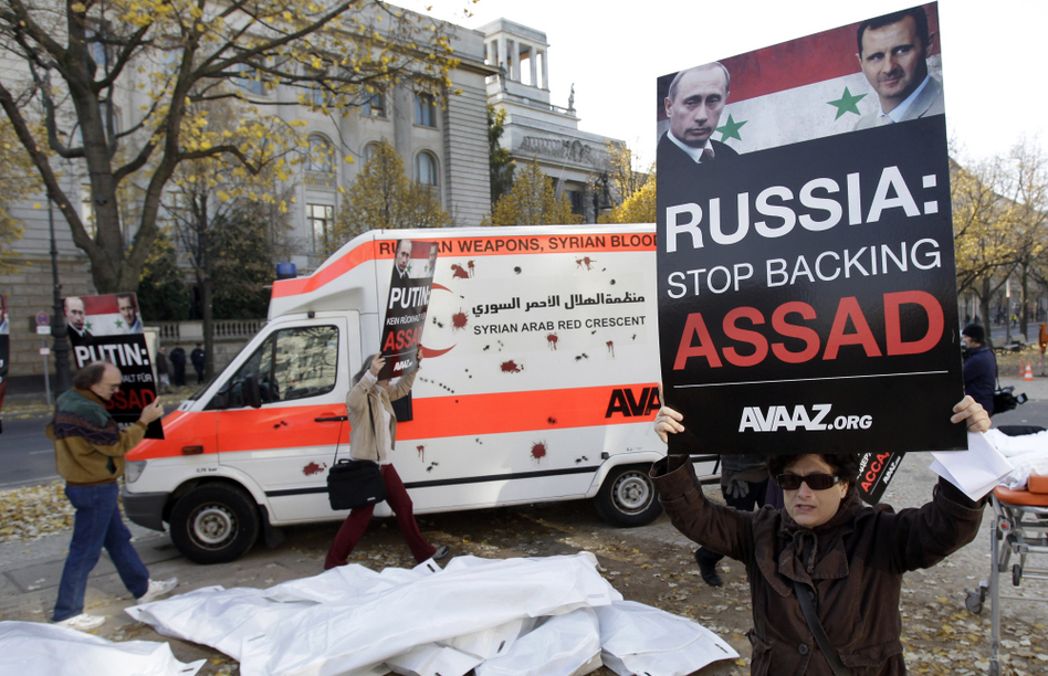Campaigners from the international advocacy group Avaaz protest Russian arms sales to the Syrian government during a demonstration in front of the Russian Embassy in Berlin on Nov. 2. (Michael Sohn/AP)