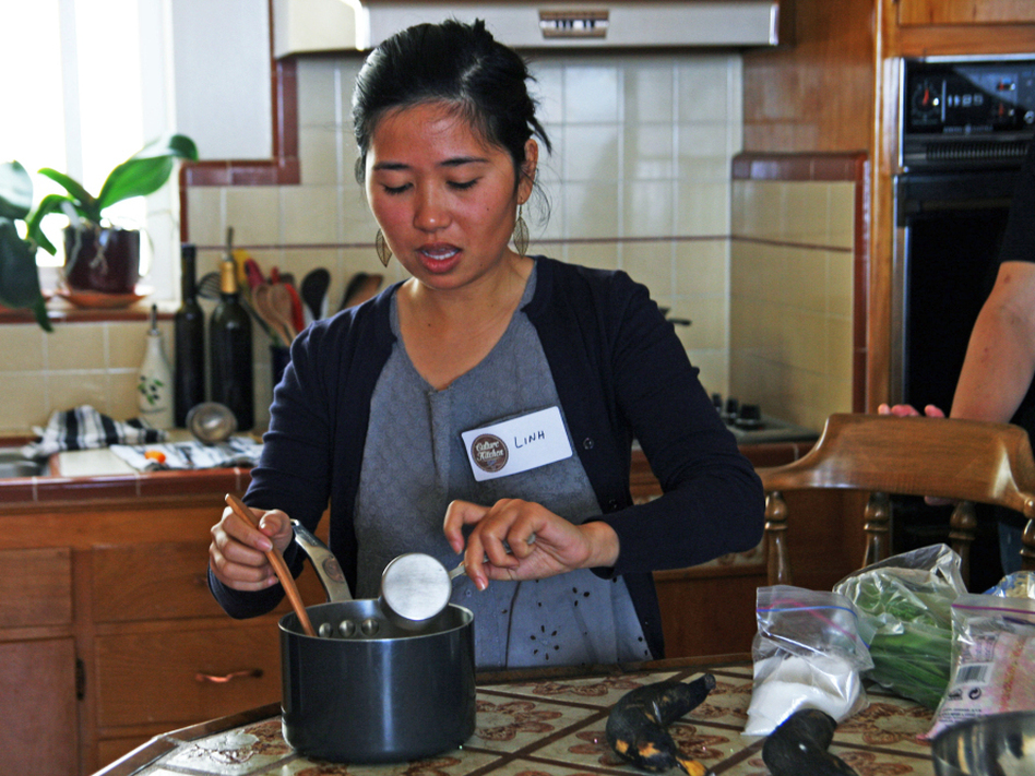 Linh Nguyen teaches the traditional Vietnamese recipes she learned from her mother and aunts to students at a Culture Kitchen class. (Deena Prichep for NPR)