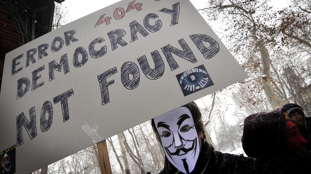 The group Anonymous has threatened to take down the Internet on Saturday to protest anti-piracy proposals that they consider online censorship. Here, a masked protester demonstrates against one such measure last month in Zagreb, Croatia, last month. (AFP/Getty Images)