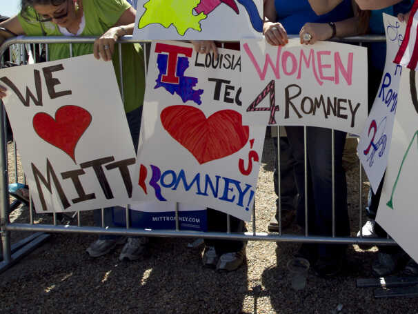 Supporters of Republican presidential candidate, former Massachusetts Gov. Mitt Romney display placards while waiting for the start of a campaign event near a natural gas drilling rig, in Shreveport, La., Friday, March 23, 2012.