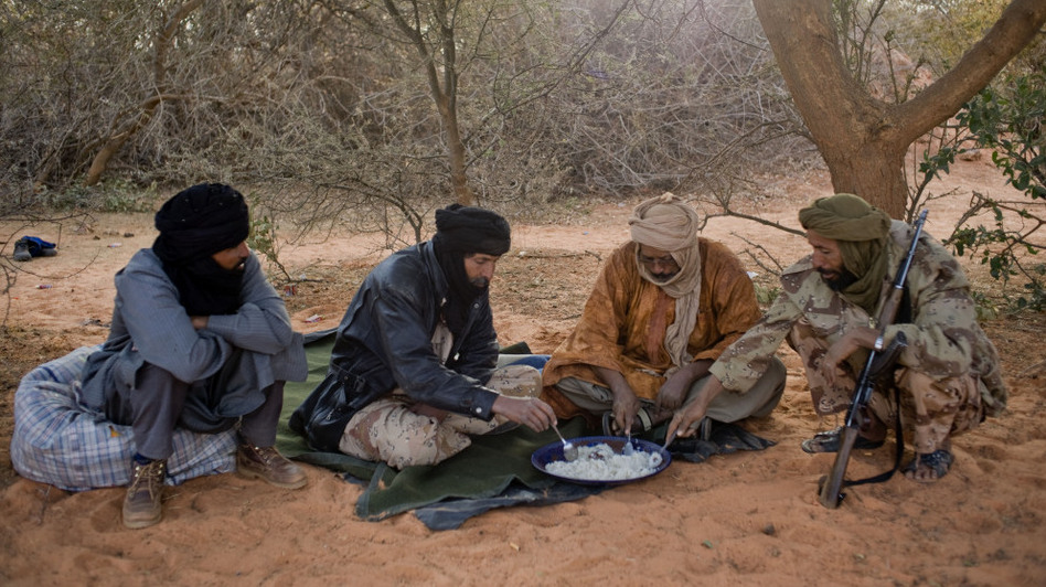 Tuareg rebels eat a meal last month near the Malian city of Timbuktu, which they recently captured. The rebels have taken control of northern Mali, raising concerns about stability in the broader region. (Ferhat Bouda/DPA/Landov)