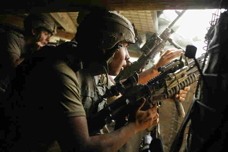 2007: Gutierrez fires a grenade launcher from the bunker at Outpost Restrepo after coming under attack by Taliban fighters.