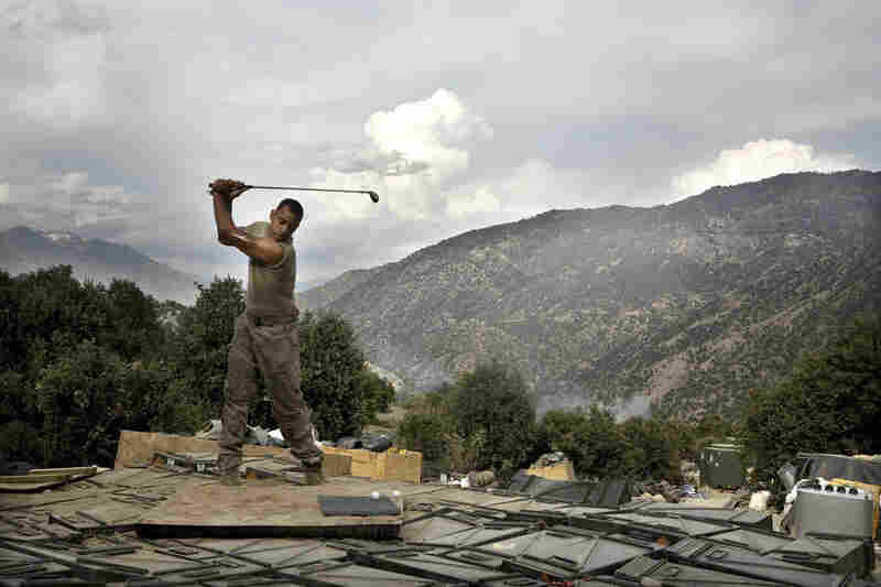 April 2008: Sterling Jones practices his golf swing. Soldiers spend about two weeks at the Restrepo outpost before returning to the main base, where they can get a hot shower and call their families. The outpost was named after 2nd Platoon medic Juan Restrepo, who was killed by insurgents.