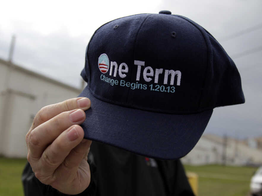 A man shows off his political swag before attending a campaign rally for Republican presidential candidate Mitt Romney at the closed National Gypsum drywall factory in Lorain, Ohio, on Thursday.