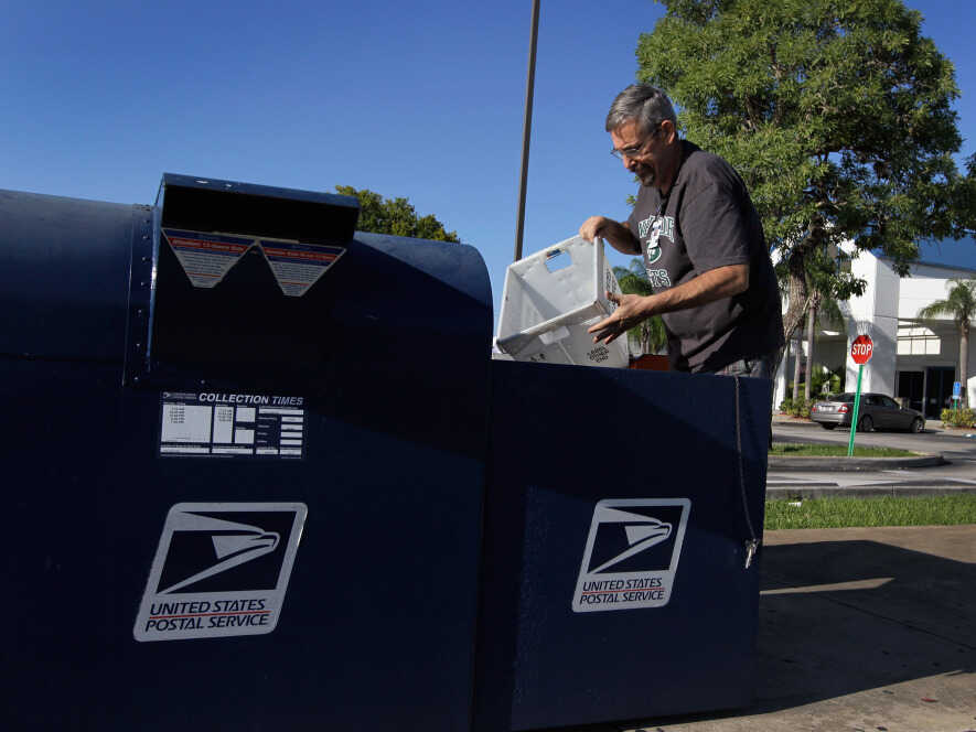 Scott Schechter, a United States Postal Service employee, collects mail from the boxes in front of a mail processing center on September 16, 2011 in Pembroke Pines, Florida. The U.S. Postal Service is considering major cost-saving measures, including the potential closings of 250 facilities nationwide are part of an effort to save up to $3 billion a year. (Joe Raedle/Getty Images)