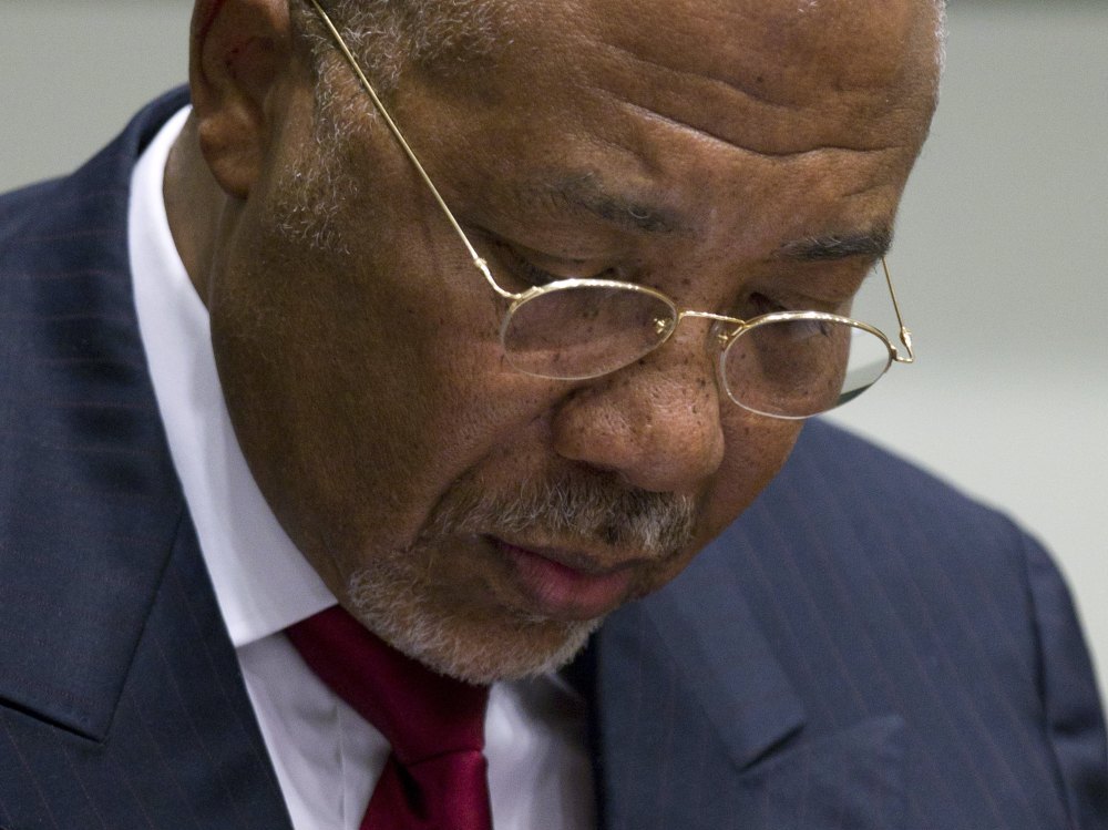 Former Liberian President Charles Taylor takes notes during his trial Thursday. He was found guilty of aiding war crimes in Sierra Leone. (Getty Images)