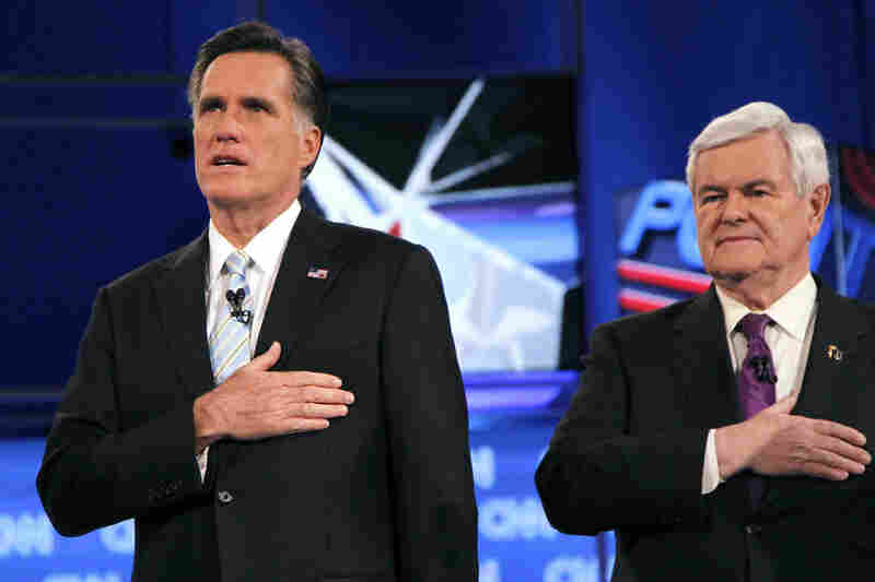 Mitt Romney and Gingrich stand for the national anthem at the Feb. 22 Republican presidential debate in Mesa, Ariz. 