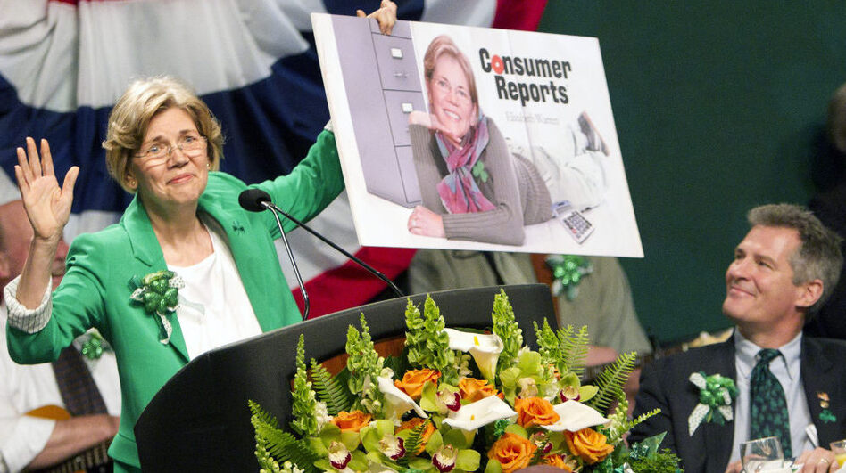 Democratic Senate candidate Elizabeth Warren holds up a poster of herself as Sen. Scott Brown, R-Mass., looks on during the annual St. Patrick's Day Breakfast in Boston on March 18. A civility pledge between the candidates has kept attack ads largely on the sidelines in their race. (Michael Dwyer/AP)