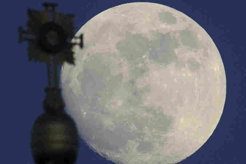 Almost full moon behind the cross of the Frauenkirche (Church of Our Lady) in Dresden, eastern Germany, on May 4, 2012. 