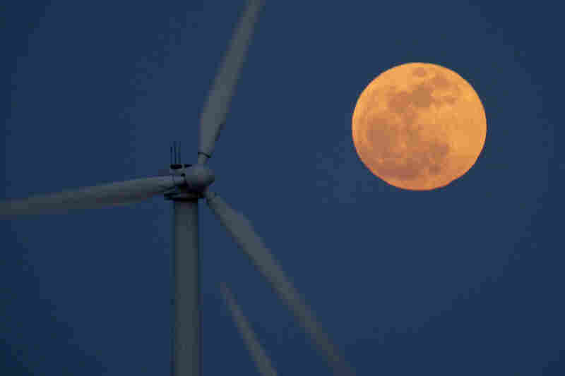 A supermoon rises behind wind turbines Saturday near Palm Springs, Calif. 