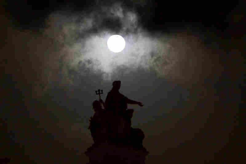 The moon is seen over the landmark Chhatrapati Shivaji Terminus in Mumbai, India, on Saturday. 