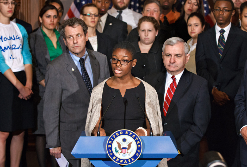 Howard University political science major Clarise McCants, flanked by Democratic Sens. Sherrod Brown and Jack Reed (right), addresses upcoming changes in federal Stafford loan interest rates at a Capitol Hill news conference Tuesday. (J. Scott Applewhite/AP)
