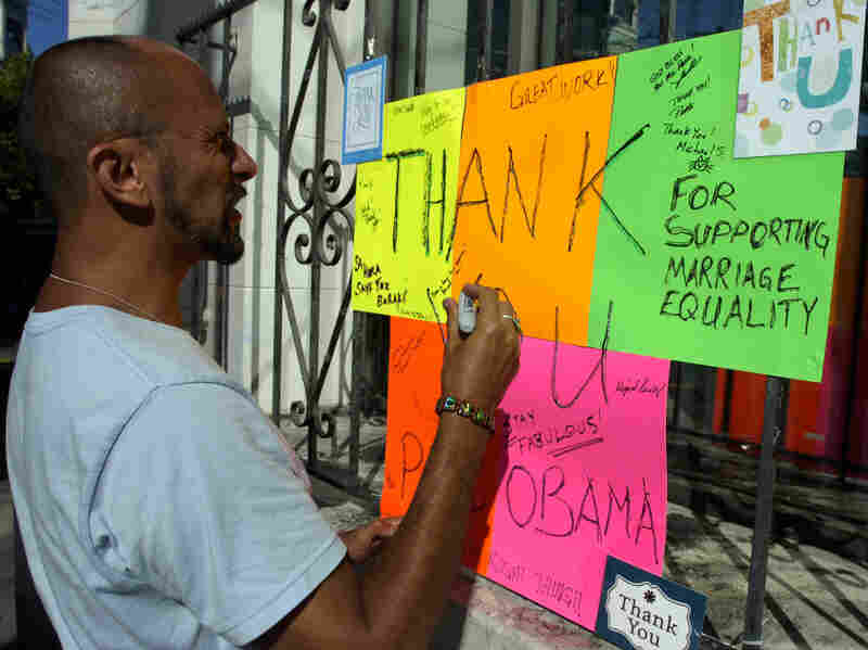 Kelly Rivera Hart of San Francisco, California, adds his thoughts to a "thank you" card for President Obama posted at the intersection of Castro and 18th Streets in San Francisco on Wednesday, May 9. Obama spoke earlier in the day of his personal beliefs on gay marriage.