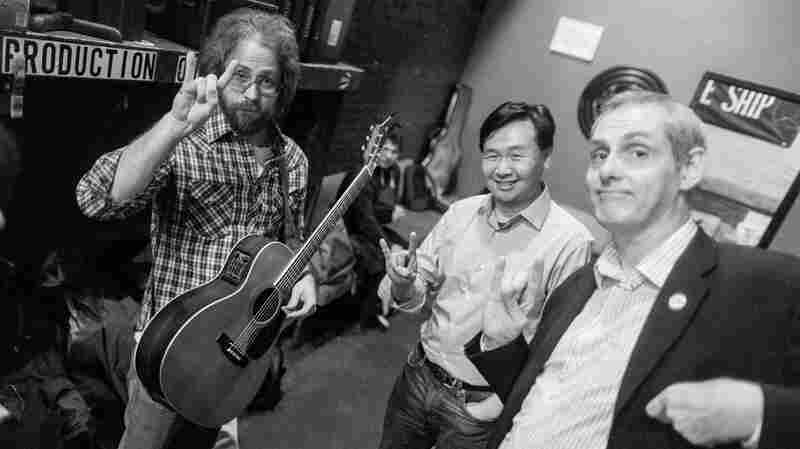 Jonathan Coulton, left, Art Chung and John Chaneski like to start each show by throwing up some horns backstage at The Bell House in Brooklyn, NY.