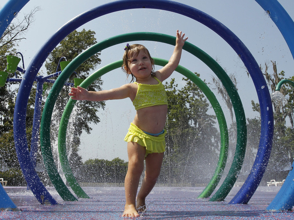 Alivia Parker, 21 months at the time, ran through circles of spraying water on a hot day in Montgomery, Ala., last June. She was wearing sunscreen with an SPF of 100, a rating that won't be allowed much longer. (Dave Martin/AP)