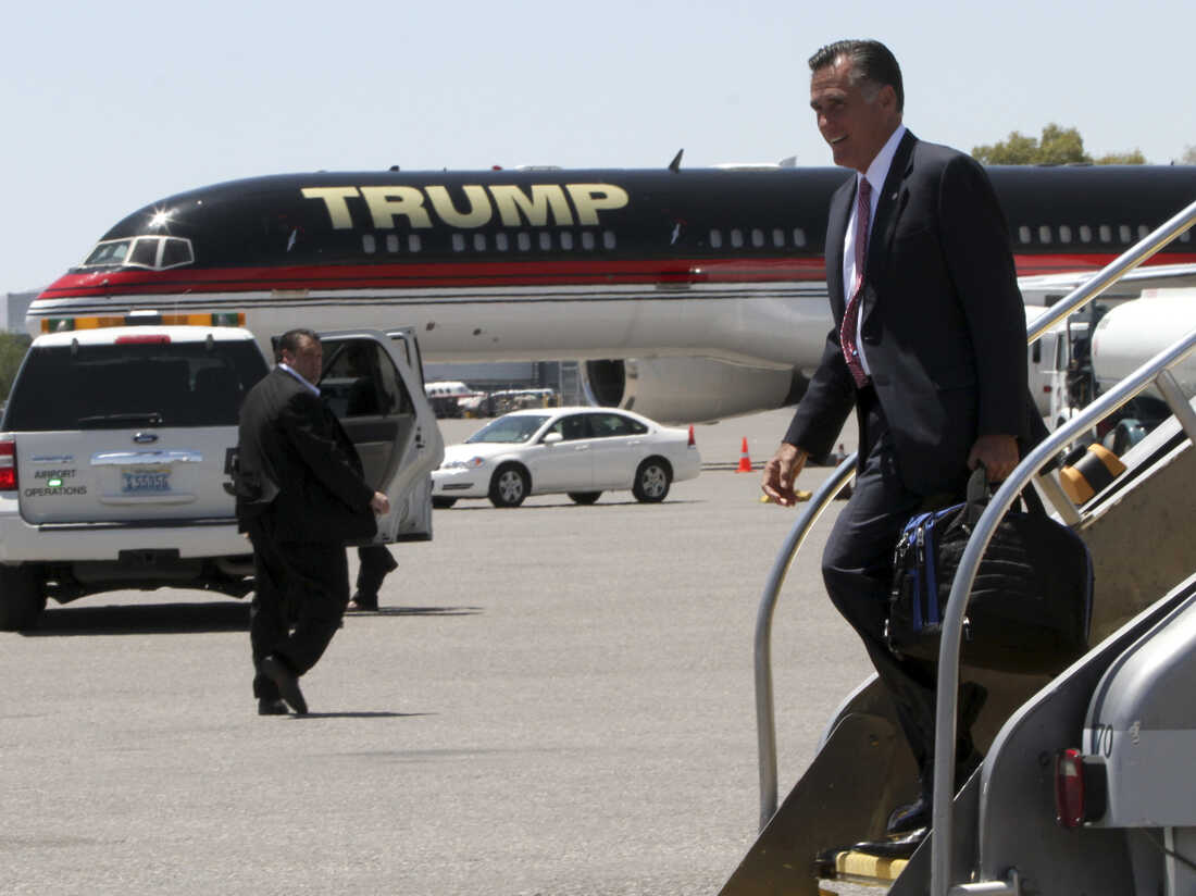 Republican presidential candidate Mitt Romney walks past Donald Trump's airplane as he arrives in Las Vegas on Tuesday, where he met with Trump for a fundraiser.