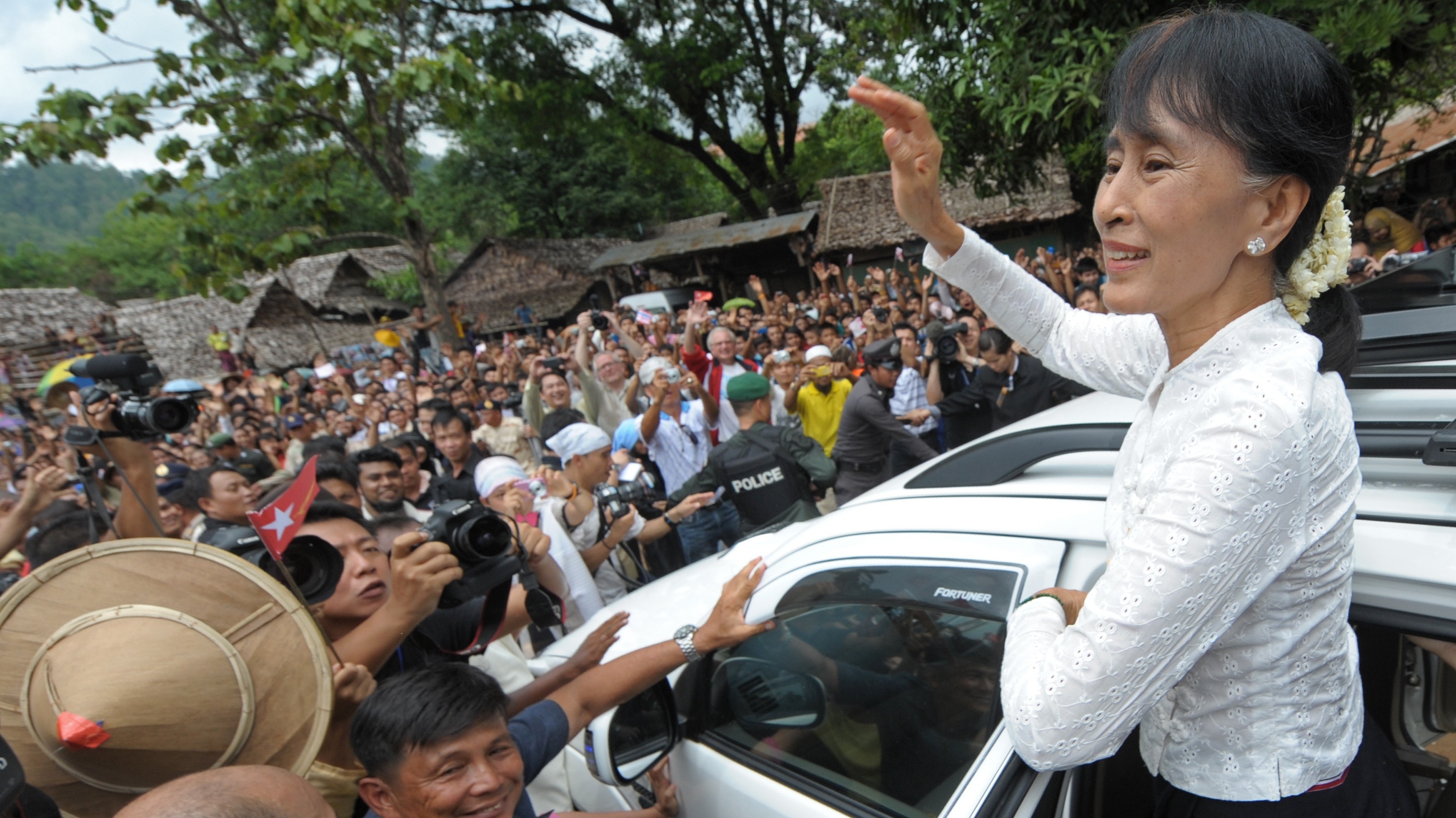 Myanmar democracy icon Aung San Suu Kyi waves to Myanmar refugees during her visit to the Mae La refugee camp near the Thai-Myanmar border on Saturday. (AFP/Getty Images)
