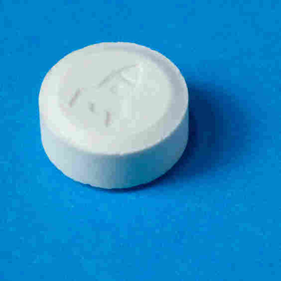 An ecstasy pill with a rocket shop imprint. An ecstasy pill with a rocket shop imprint.