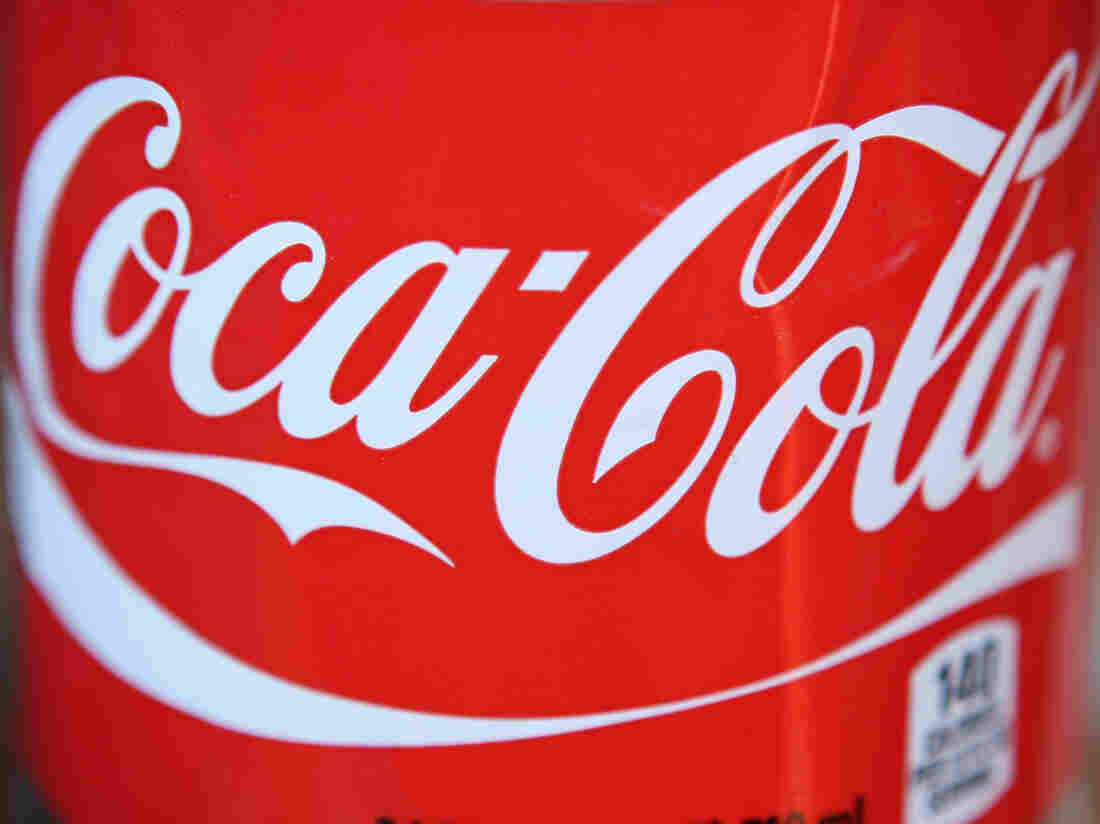 The Coca-Cola logo on a 24-ounce bottle.