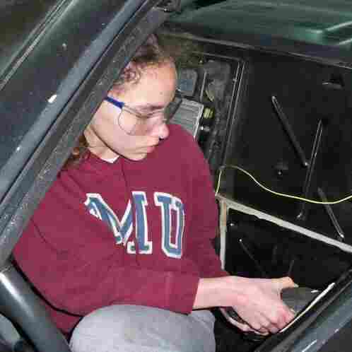 14-year-old Kathryn DiMaria drilling door rivets in her Pontiac Fiero. 14-year-old Kathryn DiMaria drilling door rivets in her Pontiac Fiero.