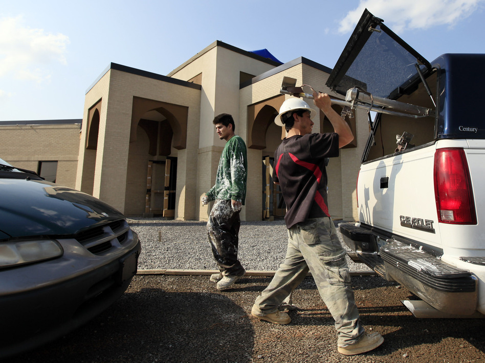 Construction workers pack up at the end of their workday at the Islamic Center in Murfreesboro, Tenn. (Mark Humphrey/AP)