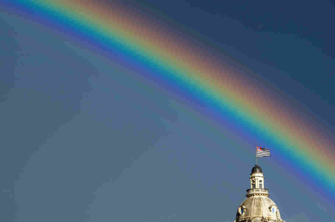 A rainbow over the flag of the Brazilian state of Sao Paulo after the rain on January 14, 2012.