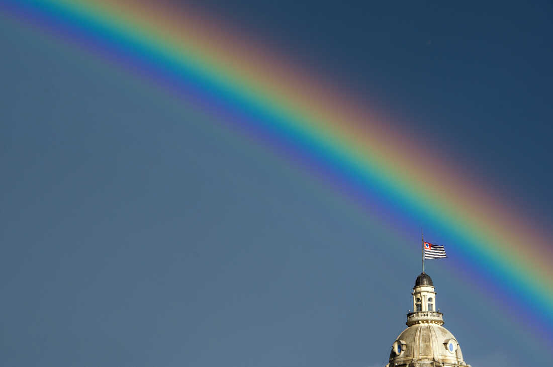 A rainbow over the flag of the Brazilian state of Sao Paulo after the rain on January 14, 2012.