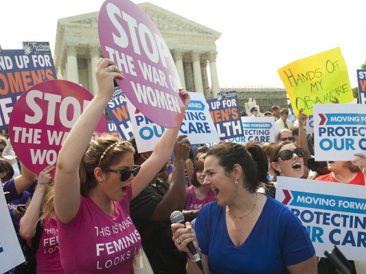 Supporters of President Obama's health care legislation celebrated outside after hearing that the Supreme Court upheld the constitutionality of the Affordable Care Act. (AFP/Getty Images)