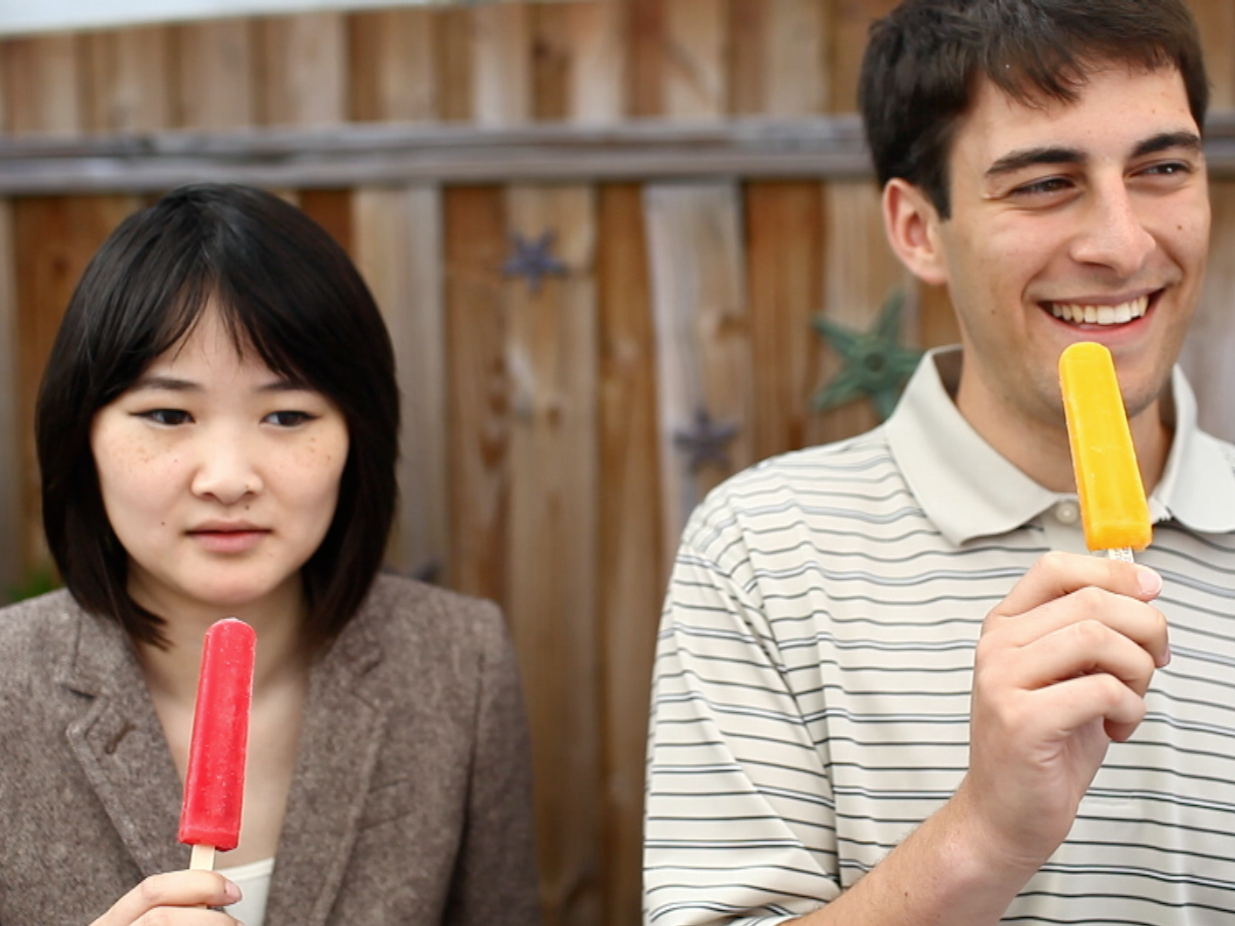 NPR interns (from left) Angela Wong and Kevin Uhrmacher participate in an experiment to induce brain freeze. (NPR)