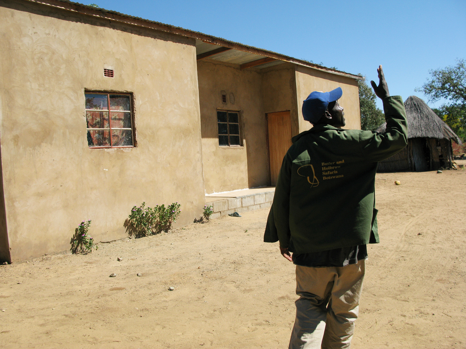 Johane Setlhare began taking anti-AIDS drugs, provided by the government, in 2007. Two years later, he regained enough strength to build the house that's behind him. (Jason Beaubien/NPR)