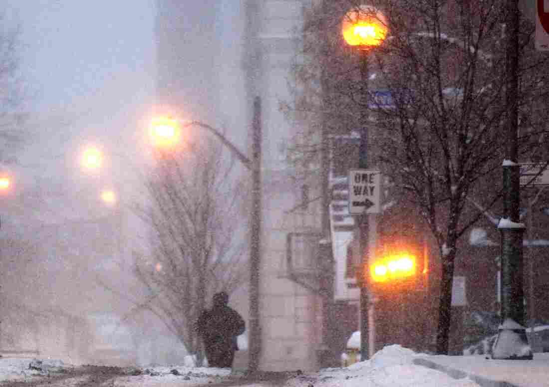 A pedestrian walks through falling snow in Pittsburgh on Jan. 12, 2011.