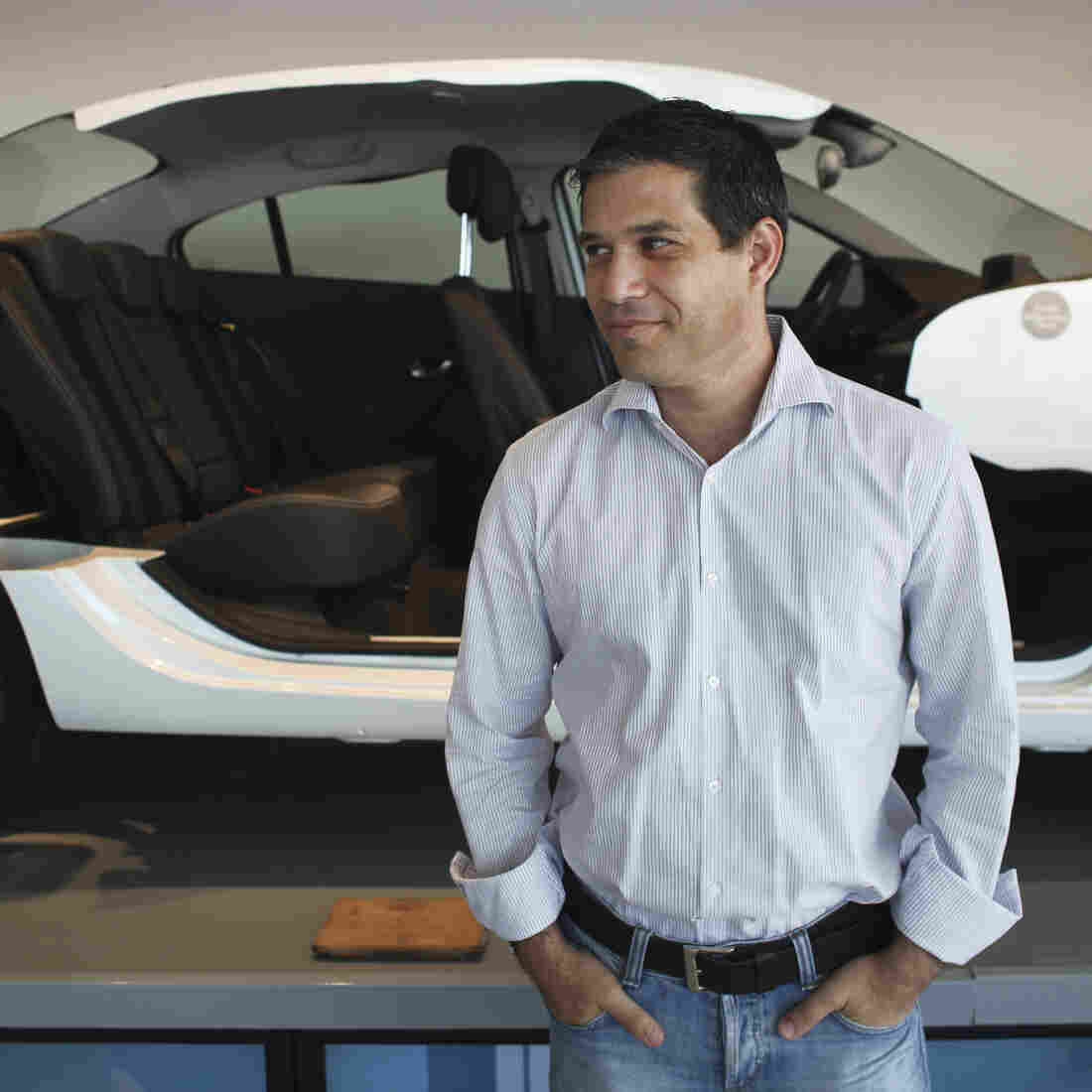 Better Place is building a network of electric car battery changing stations throughout Israel. The idea is to make changing a spent electric battery as easy as pulling into the gas station for gasoline. Here, Better Place CEO Shai Agassi is shown in front of a cutaway model of an electric car at the company's showroom in Tel Aviv earlier this month. Better Place is building a network of electric car battery changing stations throughout Israel. The idea is to make changing a spent electric battery as easy as pulling into the gas station for gasoline. Here, Better Place CEO Shai Agassi is shown in front of a cutaway model of an electric car at the company's showroom in Tel Aviv earlier this month.