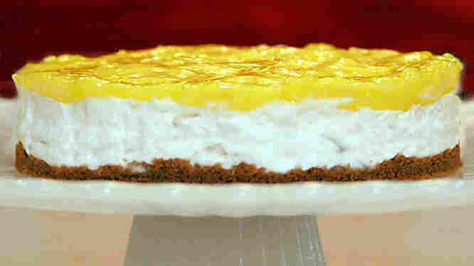 A Lemon Icebox Cheesecake on a cake stand