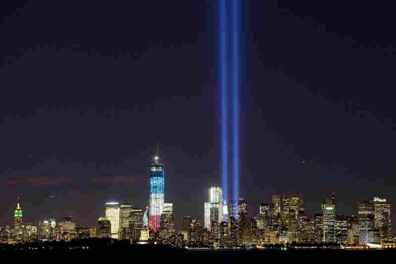 The Tribute in Light shines above the World Trade Center and the Statue of Liberty on Monday as seen from Bayonne, N.J. Tuesday marks the 11th anniversary of the attack that destroyed the twin towers.