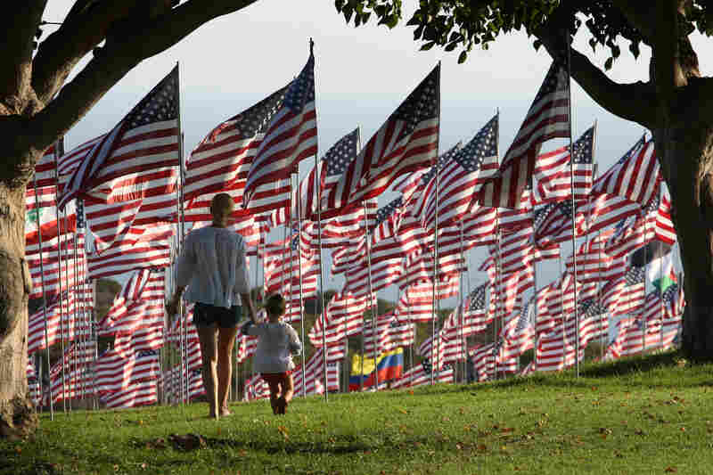 Dominique Sanders walks Monday with her daughter Roux, 2, among flags flying at Pepperdine University in Malibu, Calif., in honor of the victims of the Sept. 11 attacks. One flag from the nationality of each person killed that day was erected at the school.