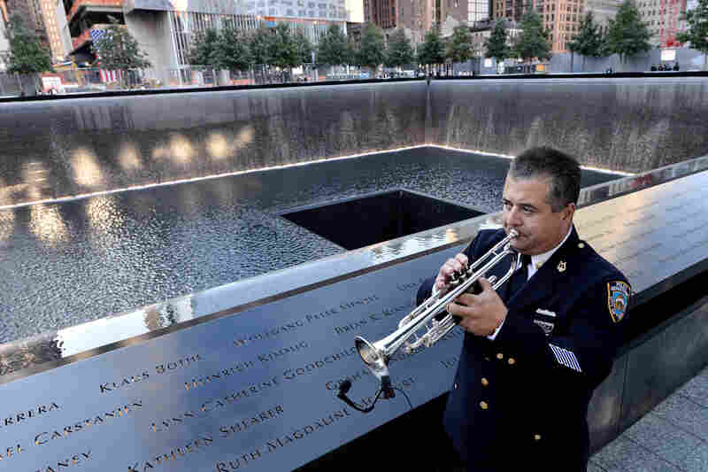 New York City police bugler Gabe Perdomo warms up next to the South Pool at ground zero during Tuesday's memorial ceremonies for the 11th anniversary of the Sept. 11 attacks.