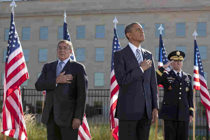 President Obama stands with Defense Defense Leon Panetta (left) and Joint Chiefs Chairman Gen. Martin Dempsey, as they place their hands over their hearts at the Pentagon Memorial,Tuesday, during a ceremony to mark the 11th anniversary of the Sept. 11 attacks in Arlington, Va.