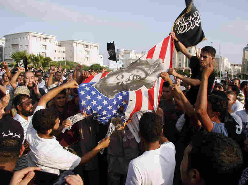 Protesters outside the U.S. embassy in Tunis burn an American flag bearing a portrait of Marilyn Monroe during a demonstration Wednesday against a film deemed offensive to Islam.