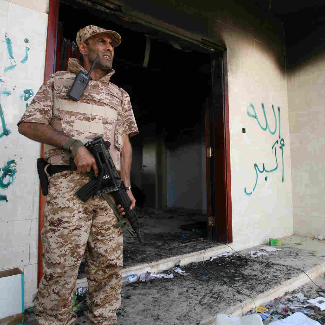 A Libyan military guard stands in front of one of the U.S. Consulate's burnt-out buildings in Benghazi Sept. 14 during the visit of President Mohammed el-Megarif. A Libyan military guard stands in front of one of the U.S. Consulate's burnt-out buildings in Benghazi Sept. 14 during the visit of President Mohammed el-Megarif.