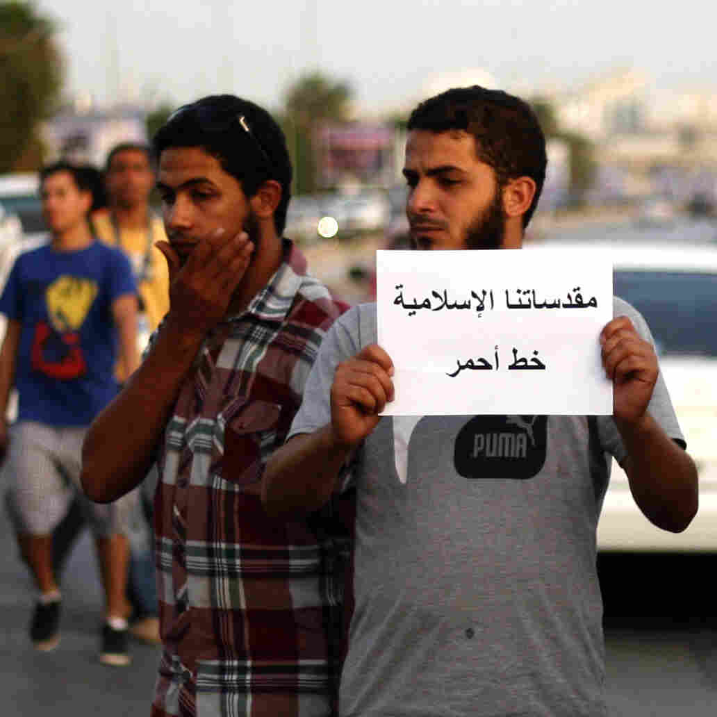 A Libyan follower of Ansar al-Sharia Brigades carries a placard reads in Arabic "our Islamic holies are red line," during a protest in front of the Tibesti Hotel, in Benghazi, Libya, on Sept. 14, as part of widespread anger across the Muslim world about a film ridiculing Islam's Prophet Muhammad. A Libyan follower of Ansar al-Sharia Brigades carries a placard reads in Arabic "our Islamic holies are red line," during a protest in front of the Tibesti Hotel, in Benghazi, Libya, on Sept. 14, as part of widespread anger across the Muslim world about a film ridiculing Islam's Prophet Muhammad.