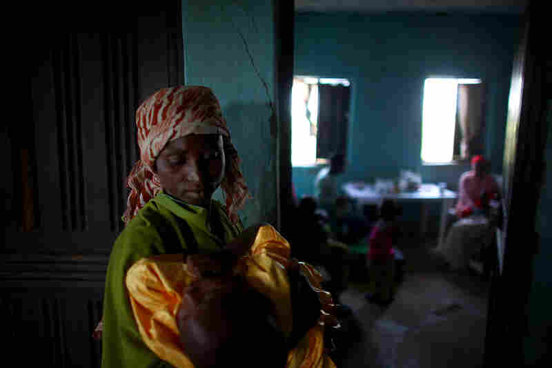 Gado Labbo holds her 5-year-old son, Yusuf, at the clinic in Dareta. In 2010, when Yusuf first entered the clinic, he had a blood lead level of 150 micrograms per deciliter — 30 times higher than what the Centers for Disease Control and Prevention considers dangerous.