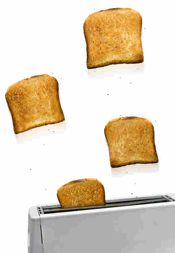 Toasts flying out of toaster.