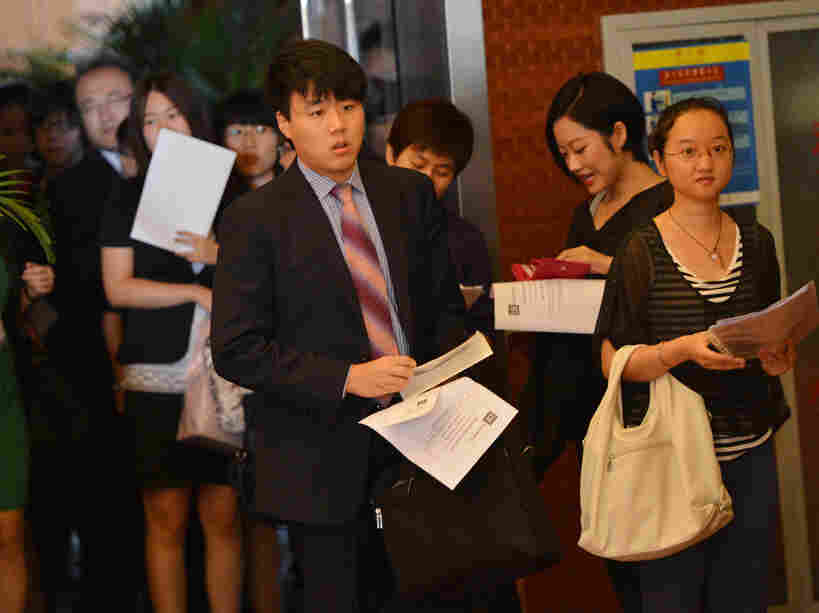 Unemployed Chinese graduates attend a career fair.