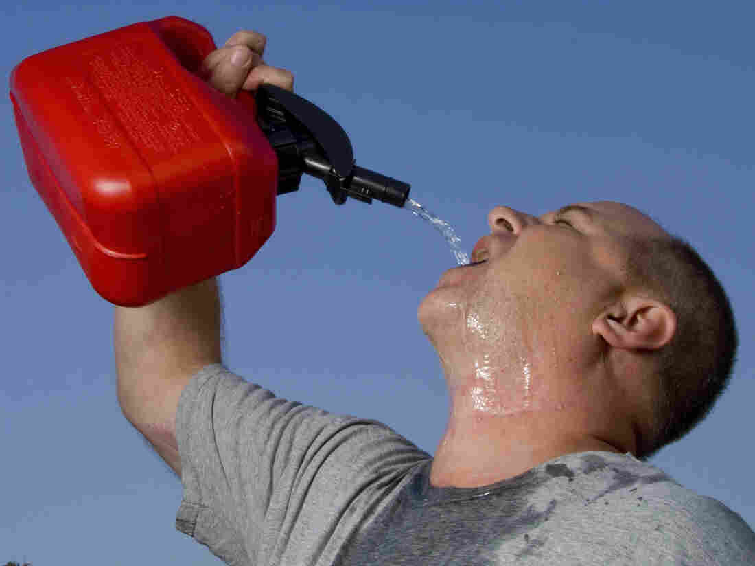 A man drinking gasoline from a gas can.
