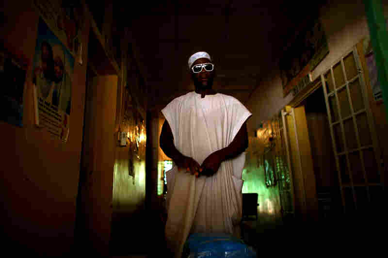 A nurse at the health clinic in Minjibir prepares to distribute free bed nets to combat malaria. Campaigns like this one, which offers services for malaria, attract local residents to the clinic. While they're there, residents are encouraged to get their children vaccinated against polio.