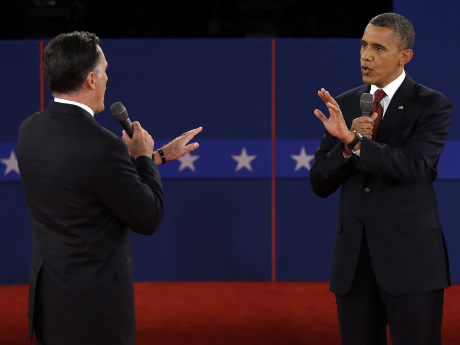 Republican presidential nominee Mitt Romney and President Obama spar over energy policy during the second presidential debate at Hofstra University on Tuesday. (Charlie Neibergall/AP)