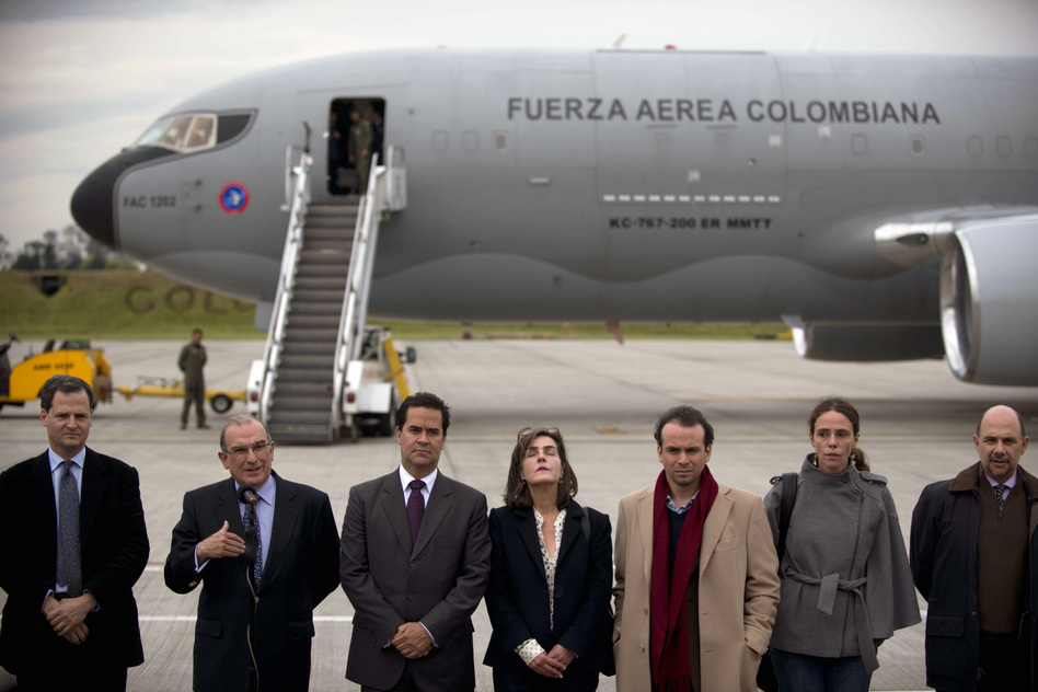 Colombia's government head of negotiators Humberto de la Calle (second to the left), speaks next to the delegation members prior to boarding a plane to Oslo, Norway, on Tuesday. (Eitan Abramovich/AFP/Getty Images)
