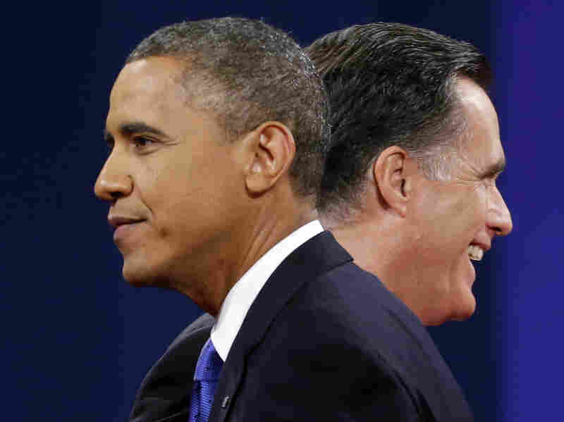 Mitt Romney and President Obama walk past each other after debating Monday in Boca Raton, Fla.